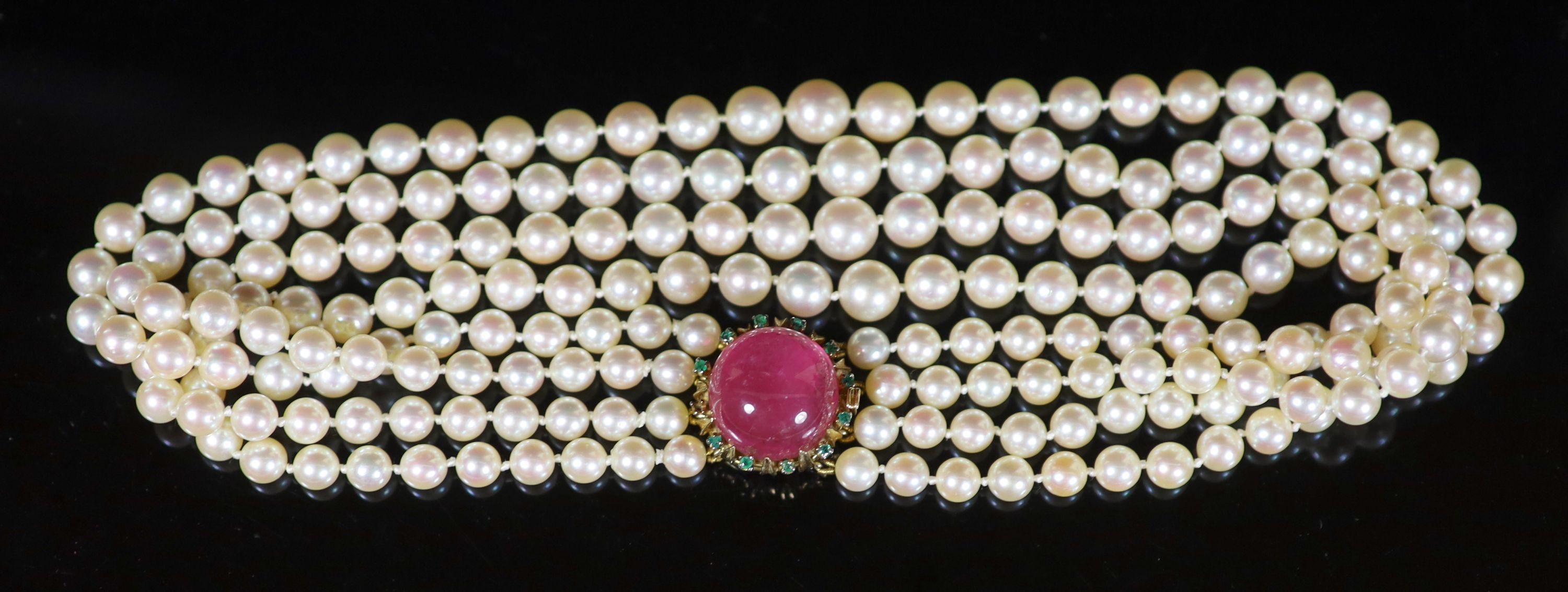 A four-strand graduated cultured pearl choker with circular cabochon pink tourmaline and emerald yellow metal clasp,